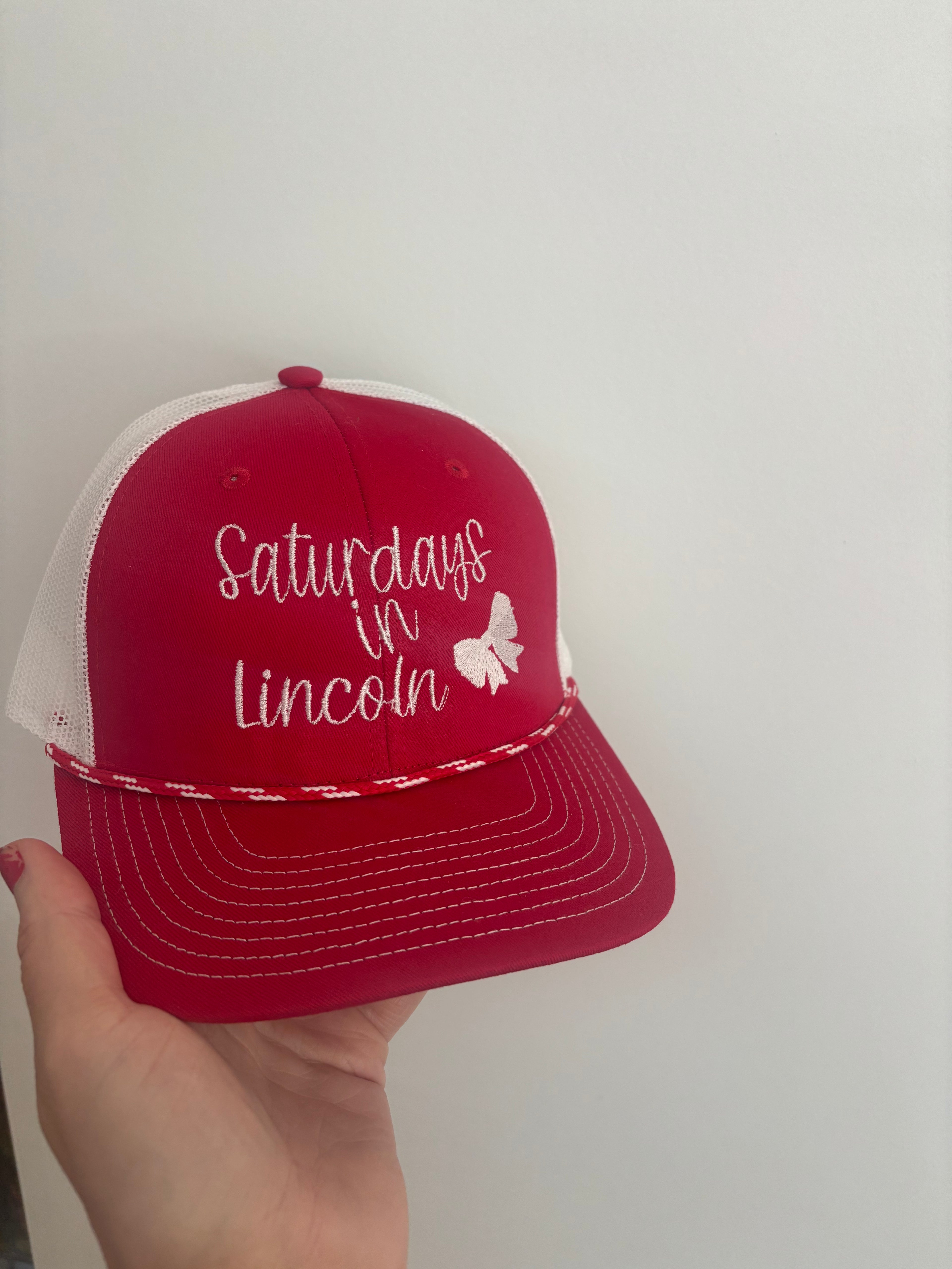 Saturdays in Lincoln Trucker Hat